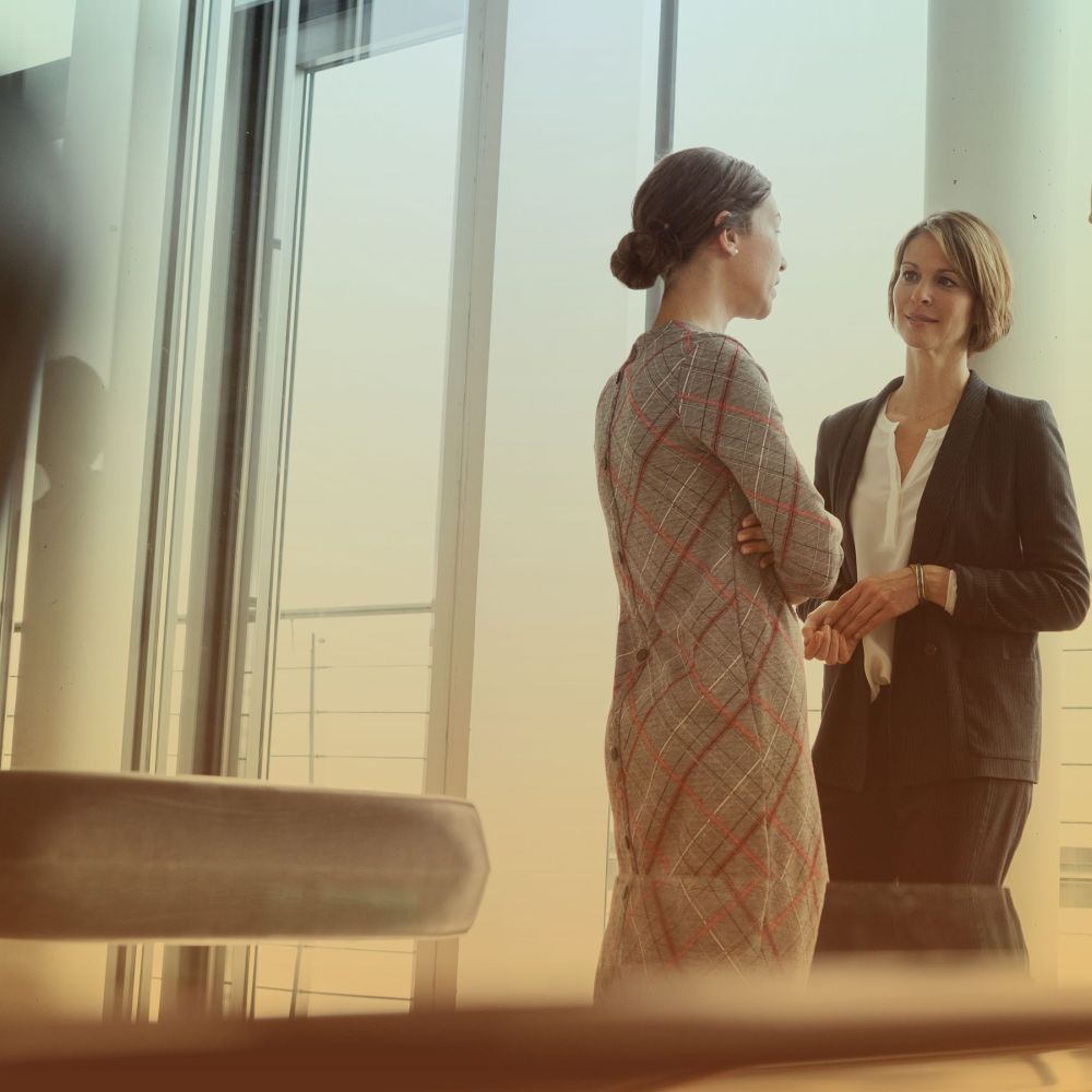 Three women having a discussion in an office